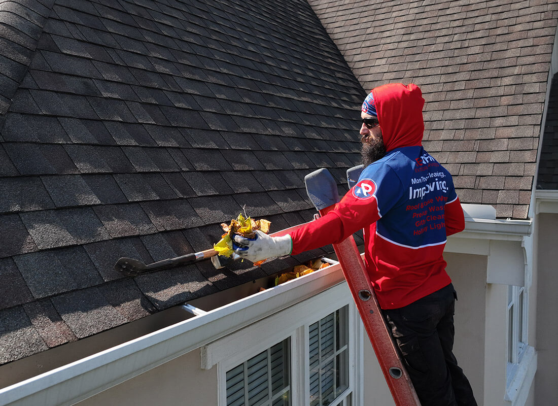 cleaning a gutter on a house